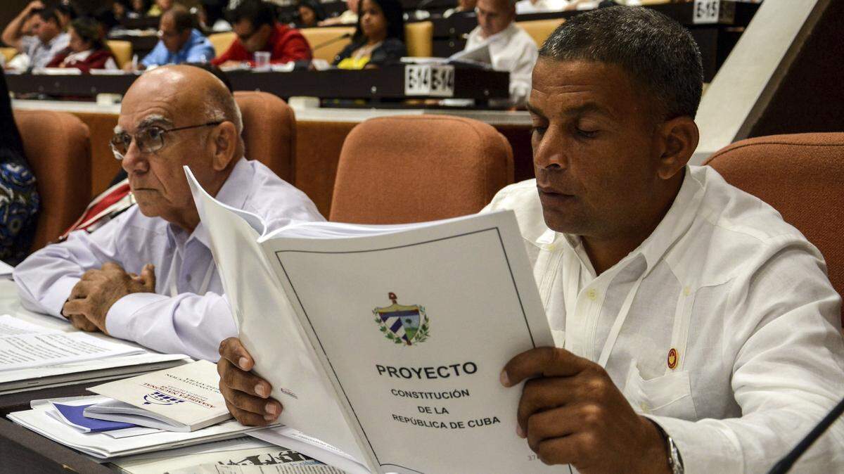 A member of the National Assembly studies the proposed update to the Constitution, in Havana, on July 21, 2018.