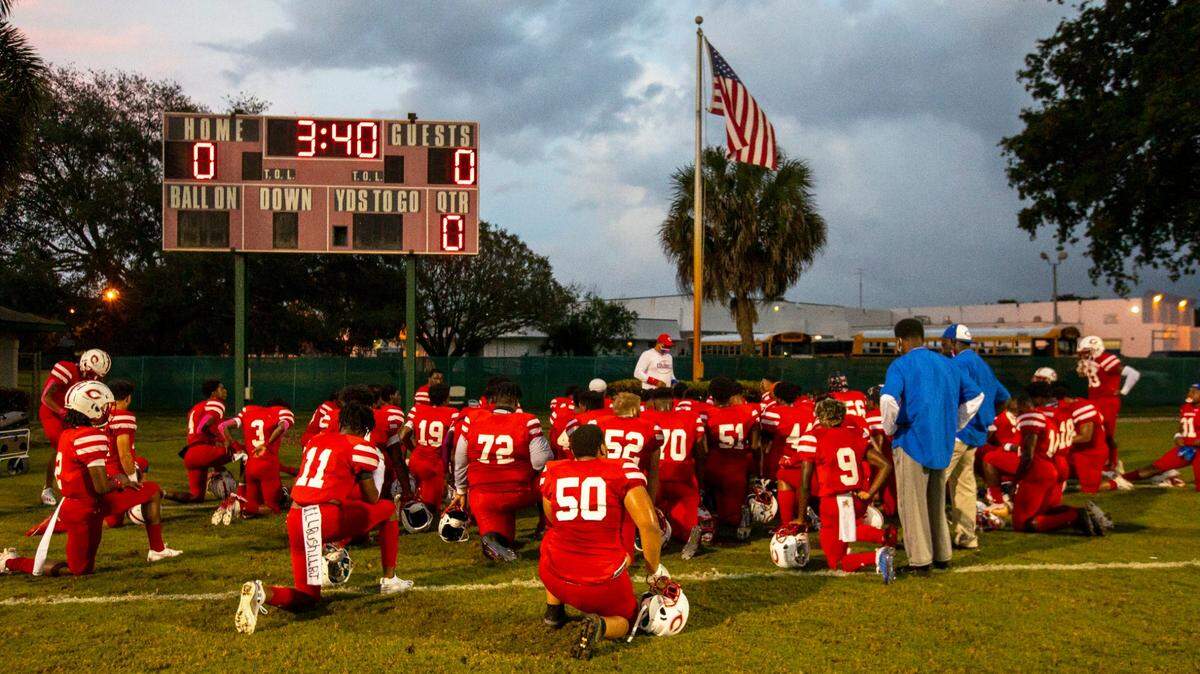 Plantation High School football team gathers for a pre-game prayer before the start of a high school football game against Western High at PAL Football Stadium Complex in Plantation, Florida, on Friday, October 30, 2020.