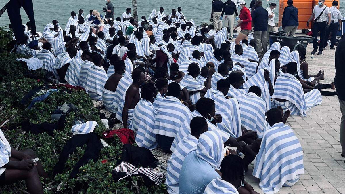 Dozens of Haitian migrants gather on shore at Ocean Reef Club, a gated community in north Key Largo, Sunday, March 6, 2022. The people are part of a large migrant group that arrived on a wooden boat that day.