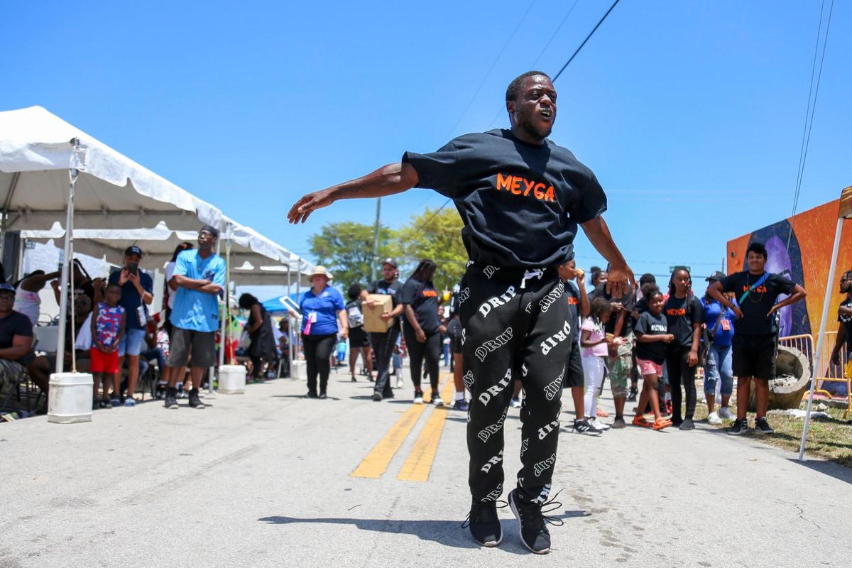 A member of the Meyga Learning Center dances during a block party to celebrate Trina Day in Liberty City, Florida, on Saturday, May 14, 2022.