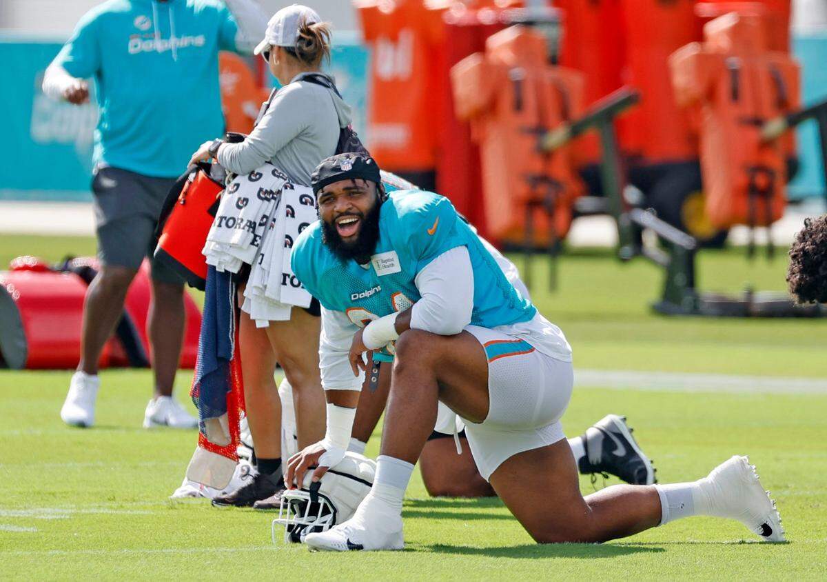 Miami DolphinsDT Christian Wilkins (94) stretches before the start of practice at the Baptist Health Training Complex in Miami Gardens on Tuesday, August 8, 2023.