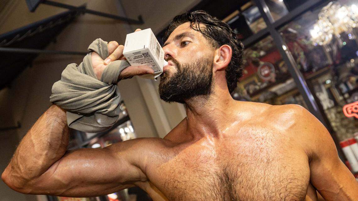 Marcel Shorago drinks a box water bottle after a run with Brickell Run Club on Tuesday, September 3, 2025, in Miami, Fla.