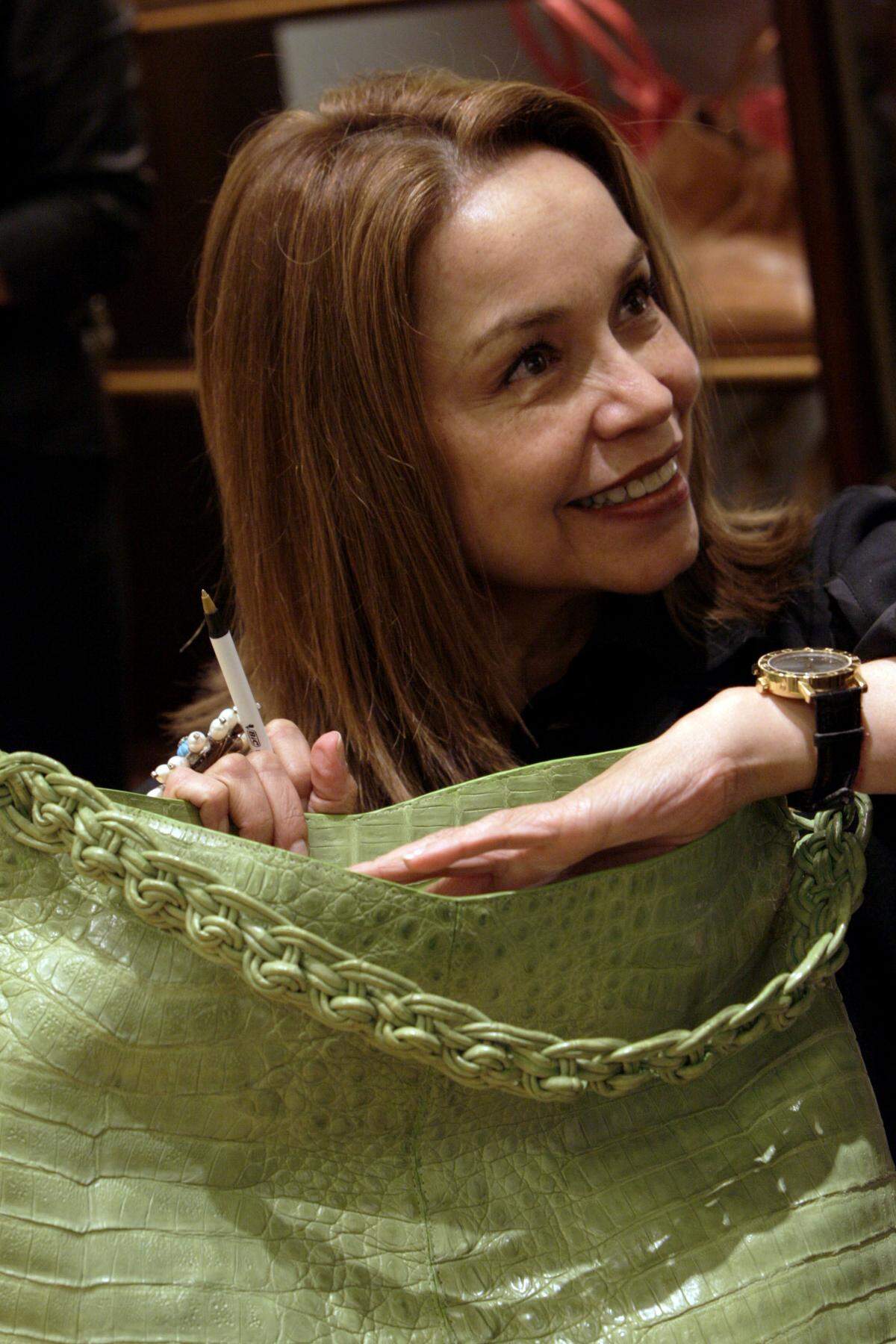 Handbag designer Nancy Gonzalez is pictured in 2008 autographing one of her bags at the Neiman Marcus store in Bal Harbour. The Colombian designer was in town to show her latest collection.