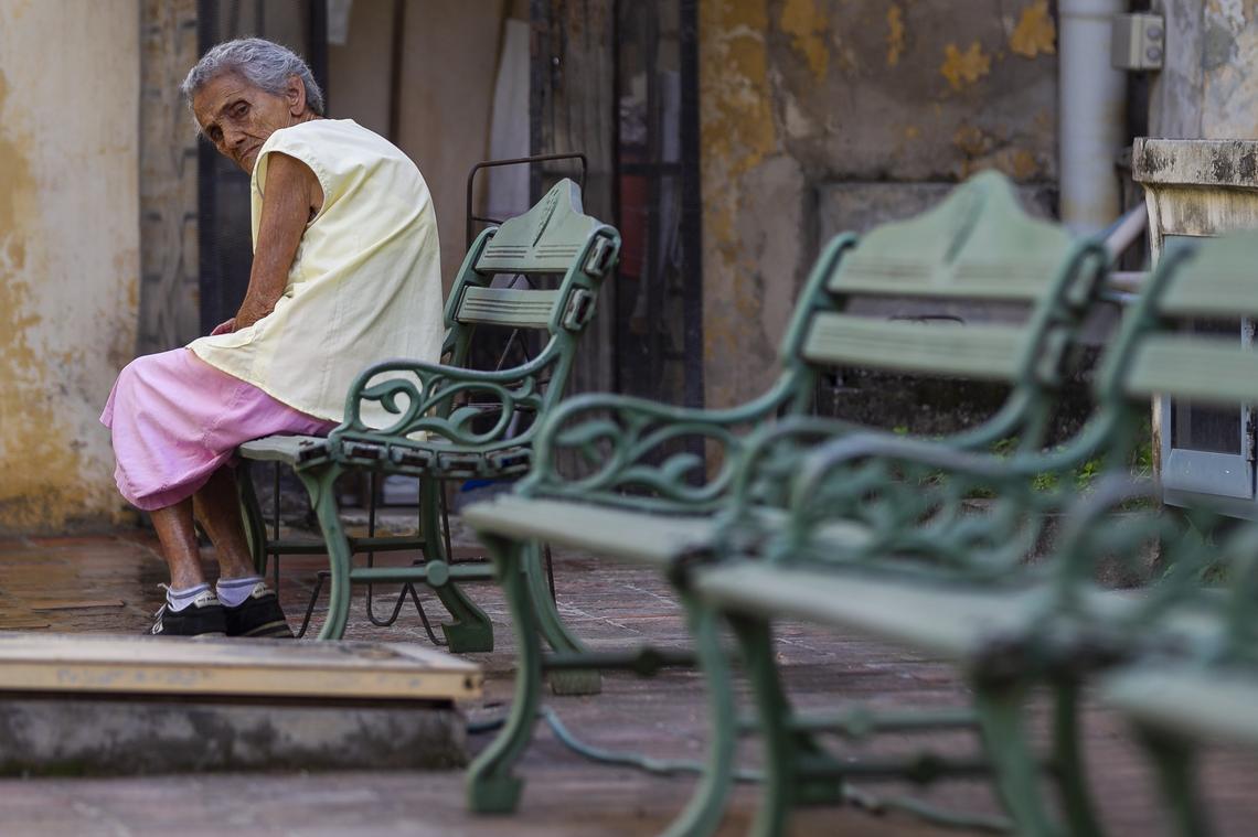 Dora Eusevia González Hernández, 92, sits on a bench inside la Merced center in Havana, Cuba.
