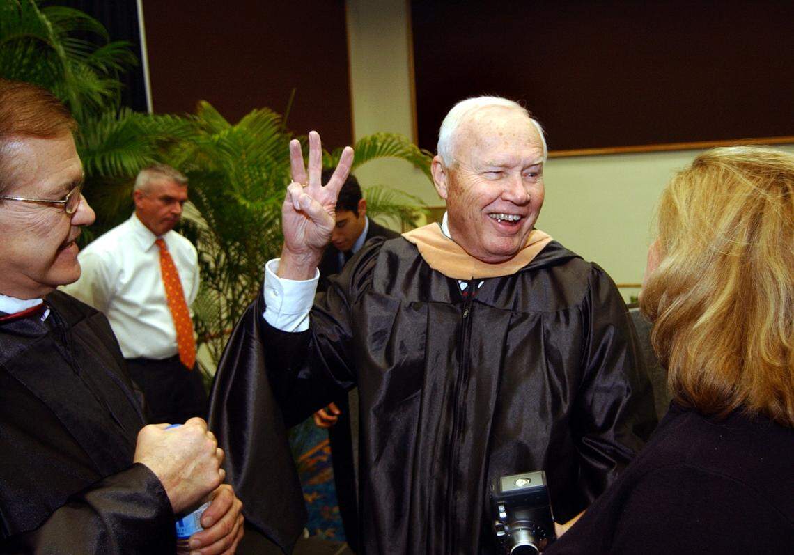 “Skipper” Chuck Zink received an honorary degree from the Art Institute of Fort Lauderdale during commencement exercises at the Broward County Convention Center on Thursday afternoon. Here, he gives the three finger salute, meaning “Peace Love and Happiness” from his Skipper Chuck show.
