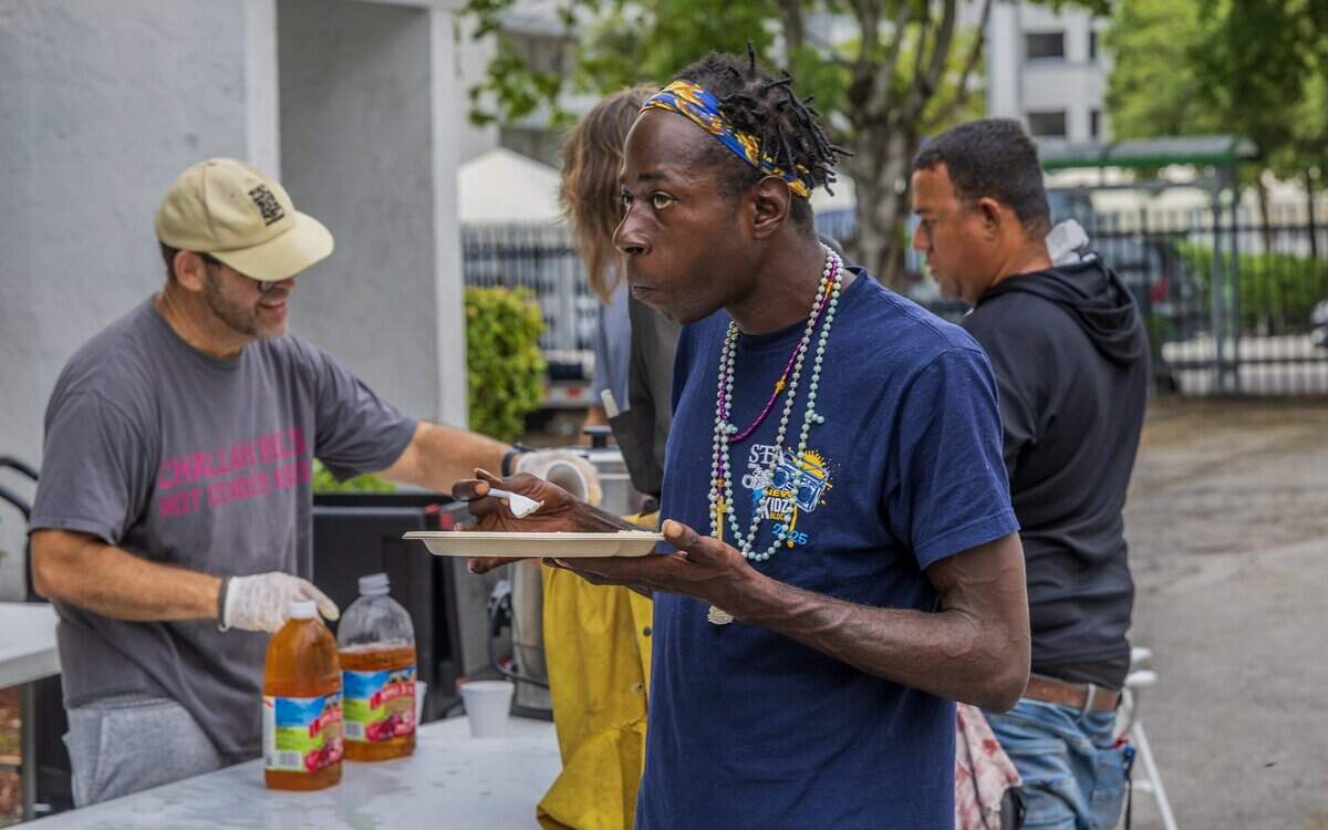 Zacharia Robinson eats breakfast during a meal drive for homeless, sponsored by Nourish Miami, a Miami-based food recovery initiative, at the Greater Bethel African Methodist Episcopal Church in Overtowm, Miami, on Friday June 05, 2026.