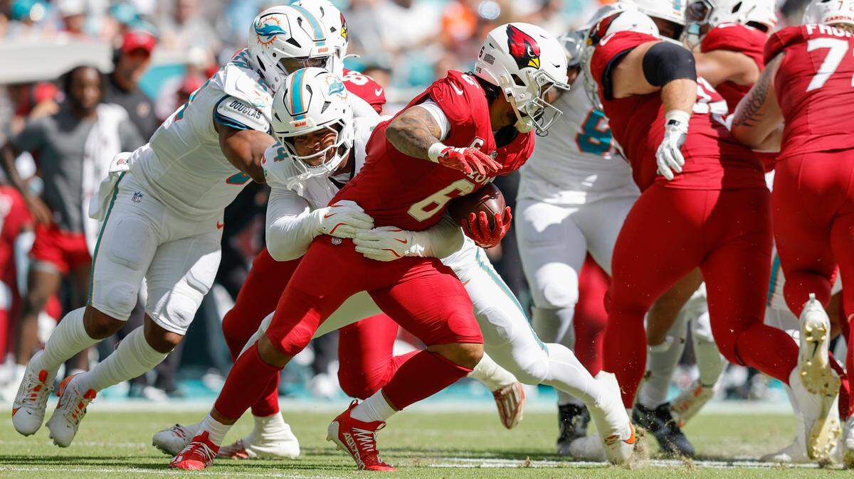 Miami Dolphins linebacker Chop Robinson (44) takes down Arizona Cardinals running back James Conner (6) in the first half during an NFL football game at Hard Rock Stadium in Miami Gardens, Florida on Sunday, October 27, 2024.