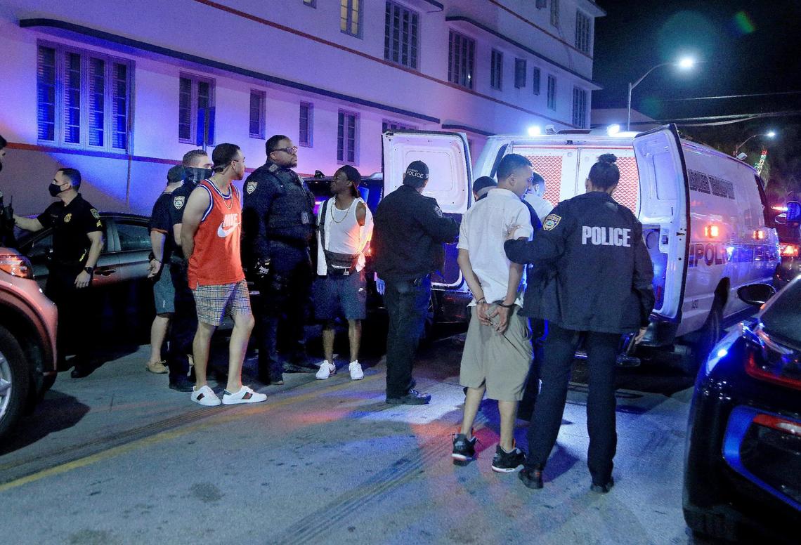 Miami Beach police officers arrest several males on Ocean Drive and 10th Street on Saturday, Feb. 20. Heading into the first weekend in March, police had arrested 355 people during spring break.