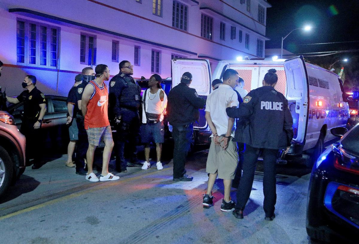 Miami Beach police officers arrest several males on Ocean Drive and 10th Street on Saturday, Feb. 20. Heading into the first weekend in March, police had arrested 355 people during spring break.