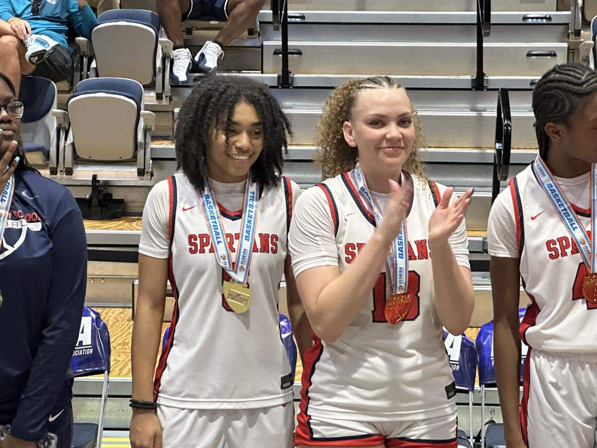 Miami Country Day’s Kamie Ellis (left) and Jalynn Belton (right) led the Spartans in scoring during their Class 2A state championship victory over Melbourne Holy Trinity on Saturday at UNF Arena in Jacksonville, Fla.