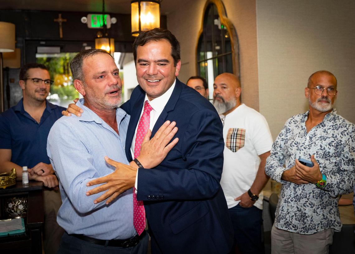 Ralph Rosado, center, is congratulated by his cousin Jose Llinas, left, during his watch party on Tuesday, June 3, 2025, at El Atlacatl restaurant in Miami.