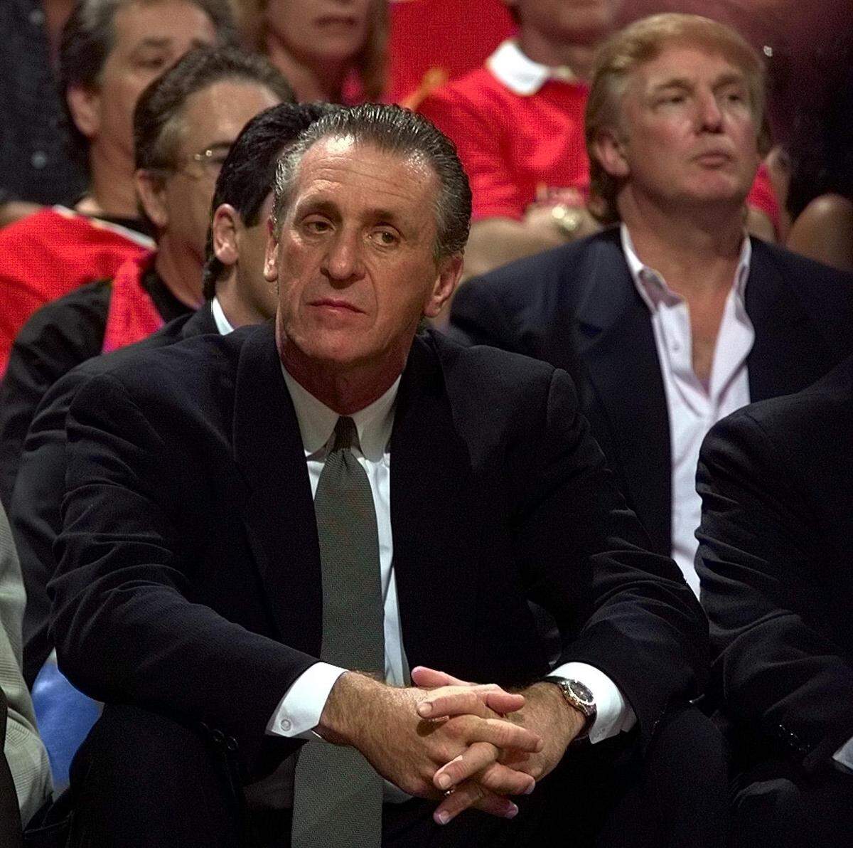 That’s the Heat’s Pat Riley on the bench and Donald Trump behind the bench during a Miami Heat playoff game against the New York Knicks in 1999 at the old Miami Arena.