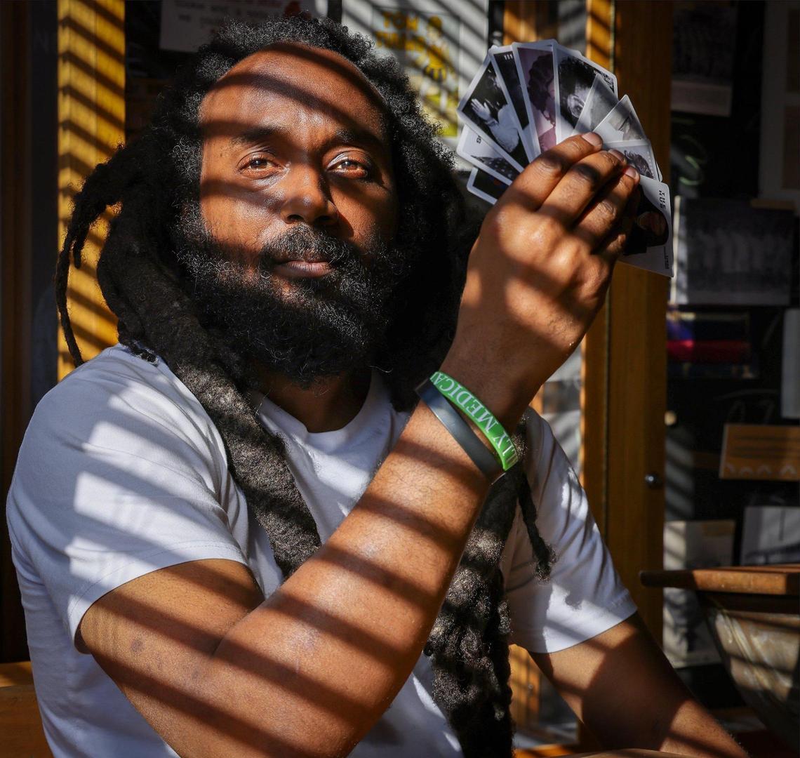 Emmanuel George, curator and community liaison at Old Dillard Museum, holds a deck of Black Broward flashcards that he created to celebrate and educate about the county’s rich Black history.