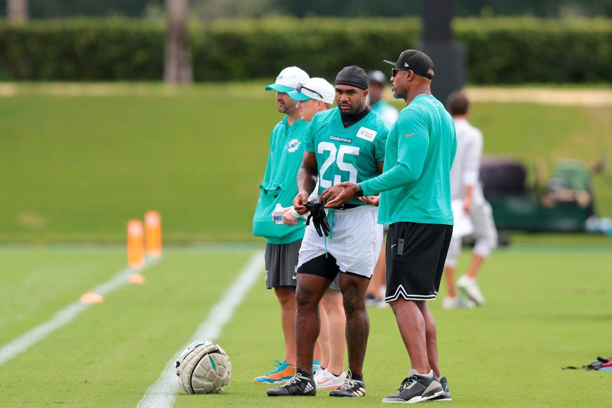 Miami Dolphins linebacker Tyrel Dodson (25) and defensive coordinator Anthony Weaver talk on the sideline during practice at Baptist Health Training Complex in Miami Gardens, Florida, Thursday, September 4, 2025.