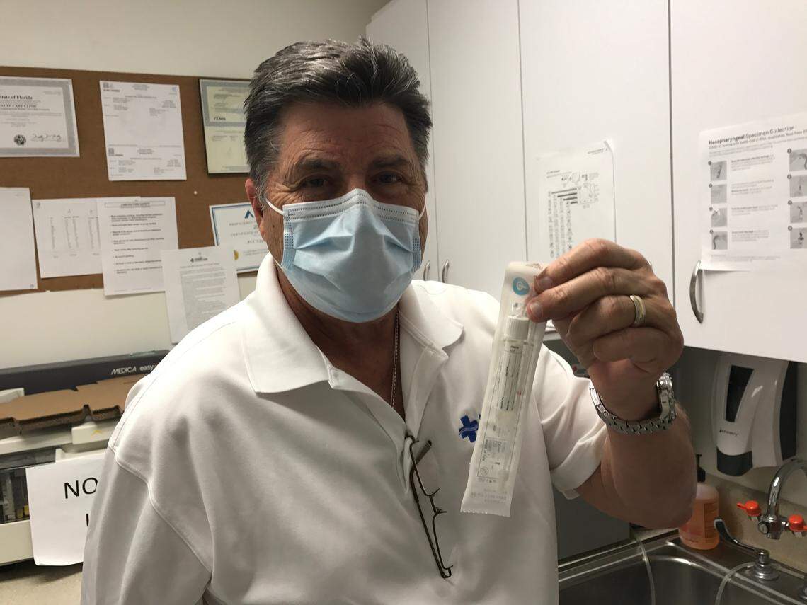 Dr. Bruce Boros, owner of Advanced Urgent Care of the Florida Keys, holds a COVID-19 testing kit at his Key Largo clinic on Thursday, April 2, 2020.