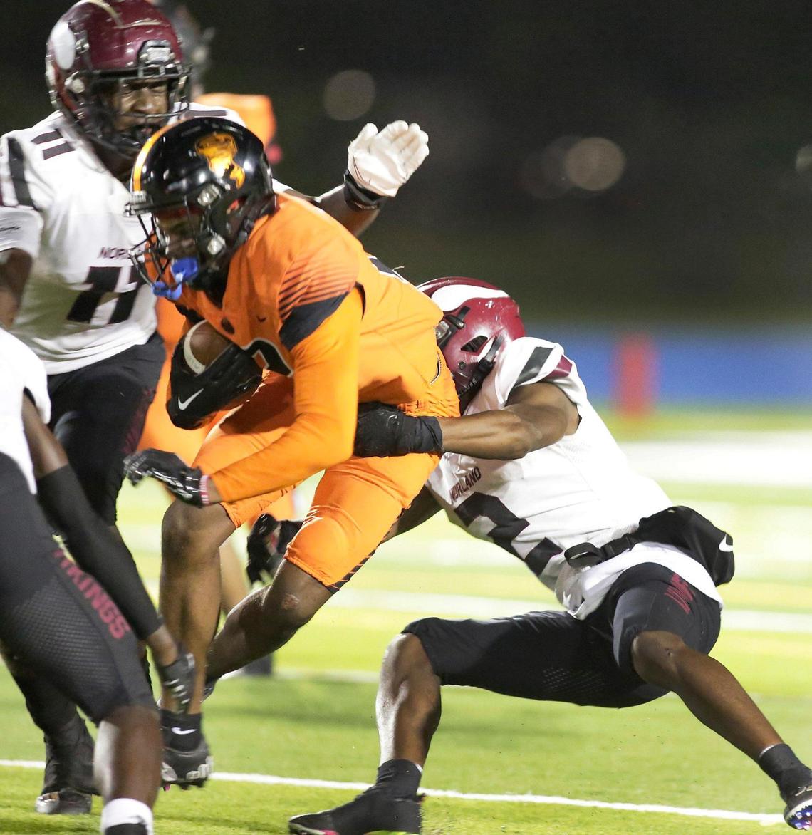 Booker T. Washington Tornadoes wide receiver Xavier Irvinisis taken down by Norland Vikings defenders during football game on Thursday, November 17, 2022 at Traz Powell Stadium in Miami. Andrew Uloza / for Miami Herald