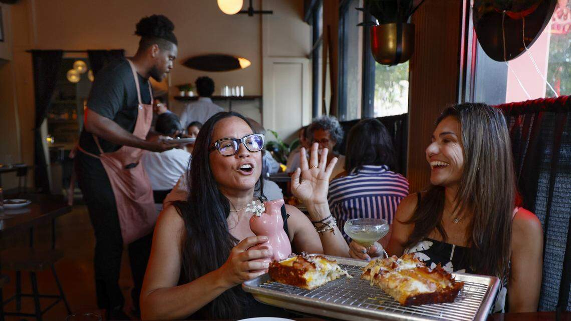 Diners Anne and Lucrecia, no last names given, enjoy dinner at Vice City Pizza in South Miami. The restaurant, formerly Bar Bella, has attracted customers looking for more affordable options this summer.
