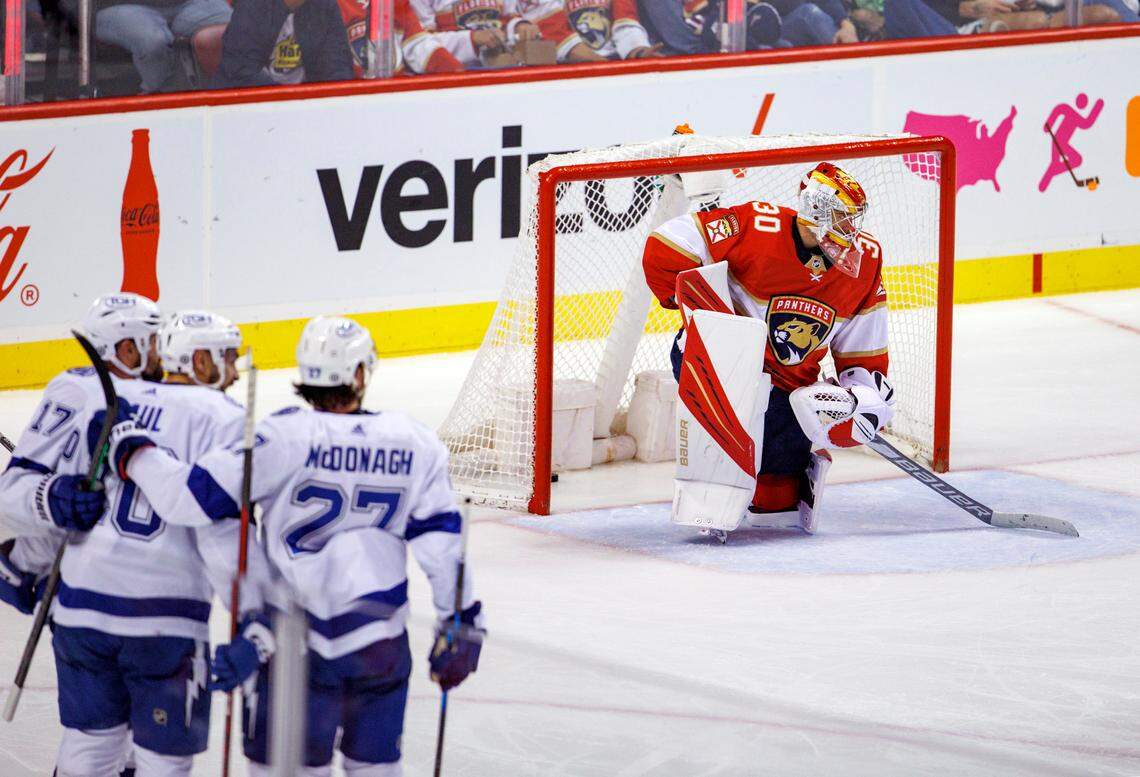 Florida Panthers goaltender Spencer Knight (30) looks on as Tampa Bay Lightning left wing Nicholas Paul (20) is congratulated by teammates after scoring a goal during the second period of an NHL game at the FLA Live Arena on Sunday, April 24, 2022 in Sunrise, Fl.