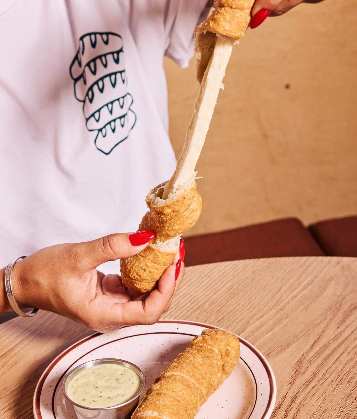 The cheese pull on the thick Caracas Bakery tequenos.