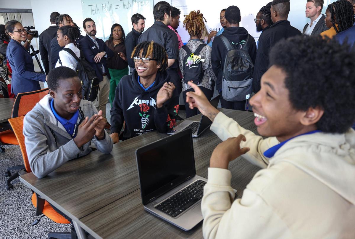 Seniors at the Academy of Information Technology - Winston Wright, 17, left, Anthony Alphonse Alvarez, 17, and Kaleb Isiah Clarke, 17, right, react to the acknowledgment of a Black Tech space for college students and community stakeholders. Black tech had a moment of rejoice on Thursday, January 26, 2023, when Florida Memorial University launched its Innovation Lab and Technoloij founder Ted Lucas announced his nonprofit’s launch alongside collaborator Chandler Malone in Miami Gardens, Florida.