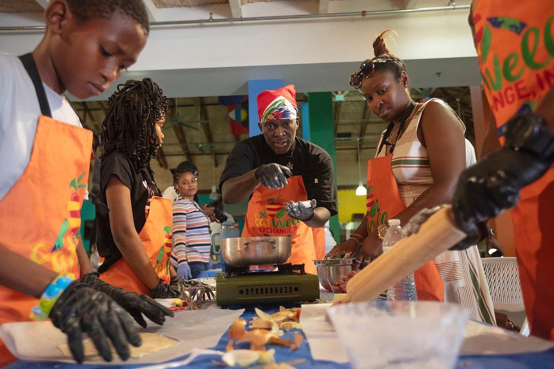 From left, counter-clockwise: Renaldine Verdieu 11; Giana Luigi Louis 10; Chef Robinson Joseph in center; Claudia Norvilus; and Timothy Louis, 15, cook during the healthy foods cooking class by Eatwell Exchange, at the Little Haiti Cultural Complex in Miami.