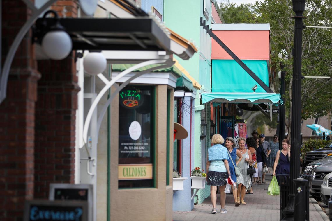 Pedestrians are seen walking by shops along Main Street on Thursday, April 20, 2023 in Dunedin.