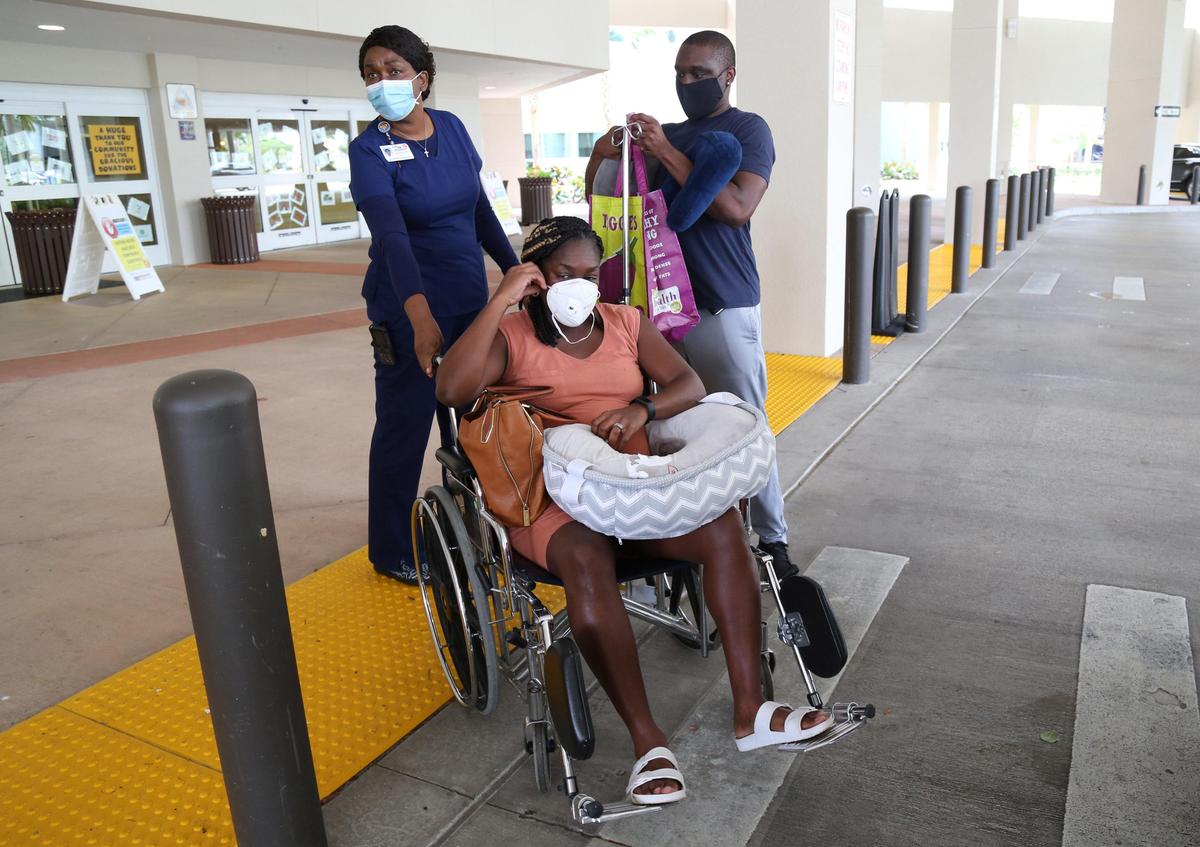 Alena and Jean Costume arrive at Memorial Hospital West in Pembroke Pines, May 14, 2020, to have their baby daughter. Due to the coronavirus pandemic, masks were required for all entering the hospital and Alena could only have Jean with her at the hospital.