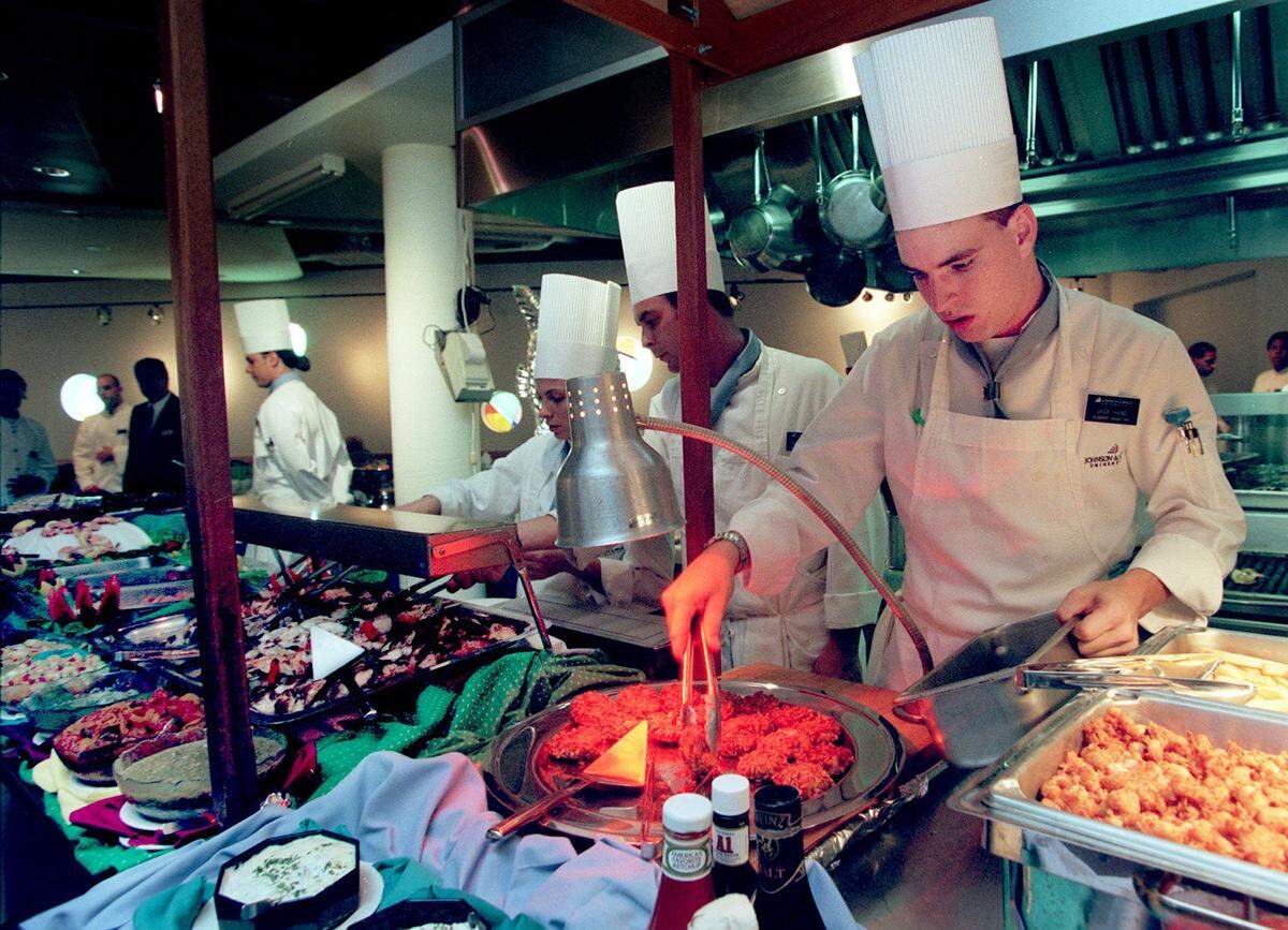 In 1996, Jack Hand replenishes the fish display at Johnson & Wales University’s campus restaurant in North Miami during the opening seafood buffet. Students prepared the food and then opened the line to the public for $24.