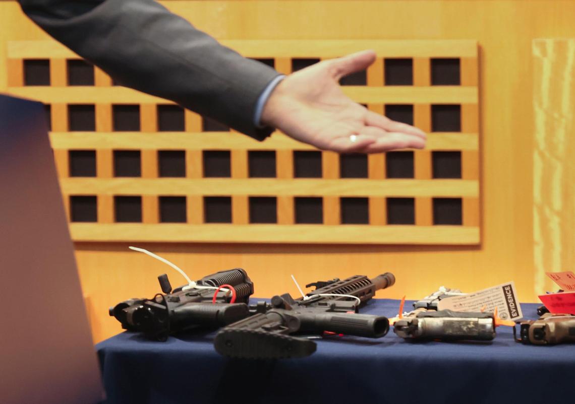 Commissioner Ken Russell gestures to 12 of the 167 guns collected during a press conference for the city’s “Guns 4 Ukraine” gun buyback program on Tuesday, July 19, 2022, at Miami City Hall.