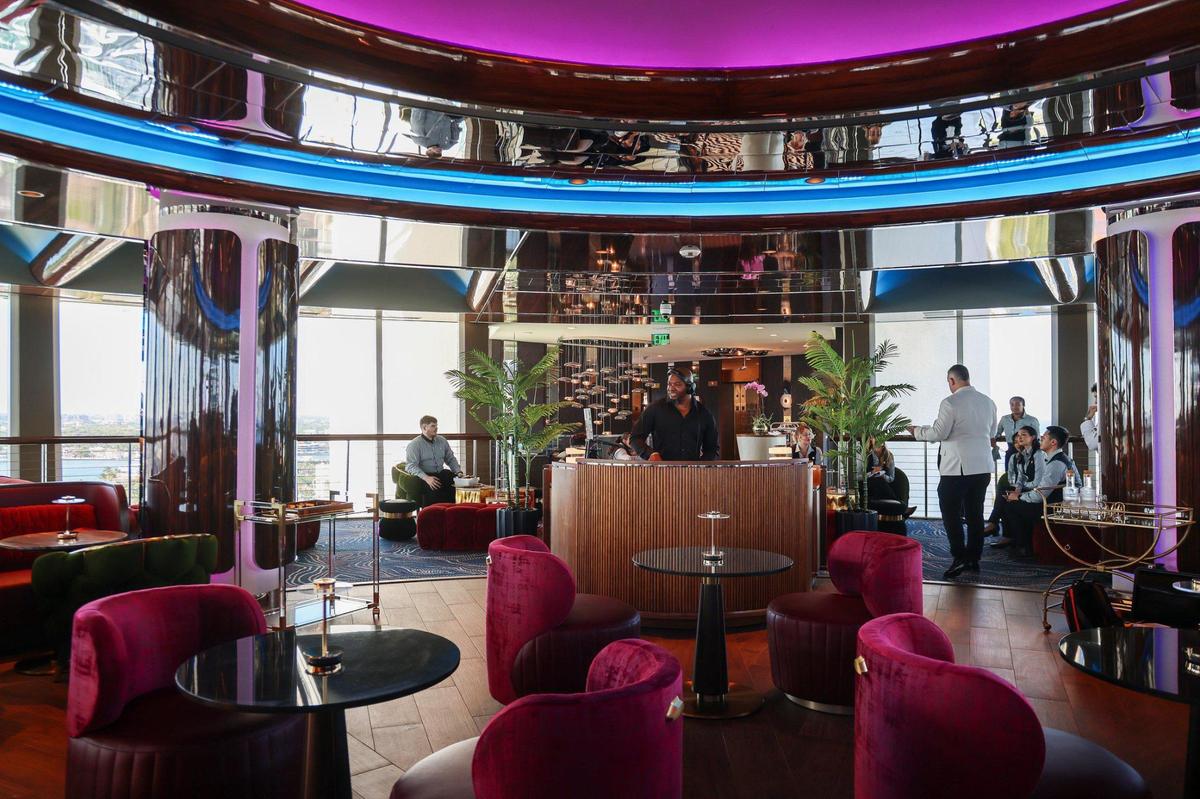 DJ Memphis, center, preps for the grand opening of the Pier Top lounge on March 20. The newly renovated space rotates 360 degrees in 66 minutes.