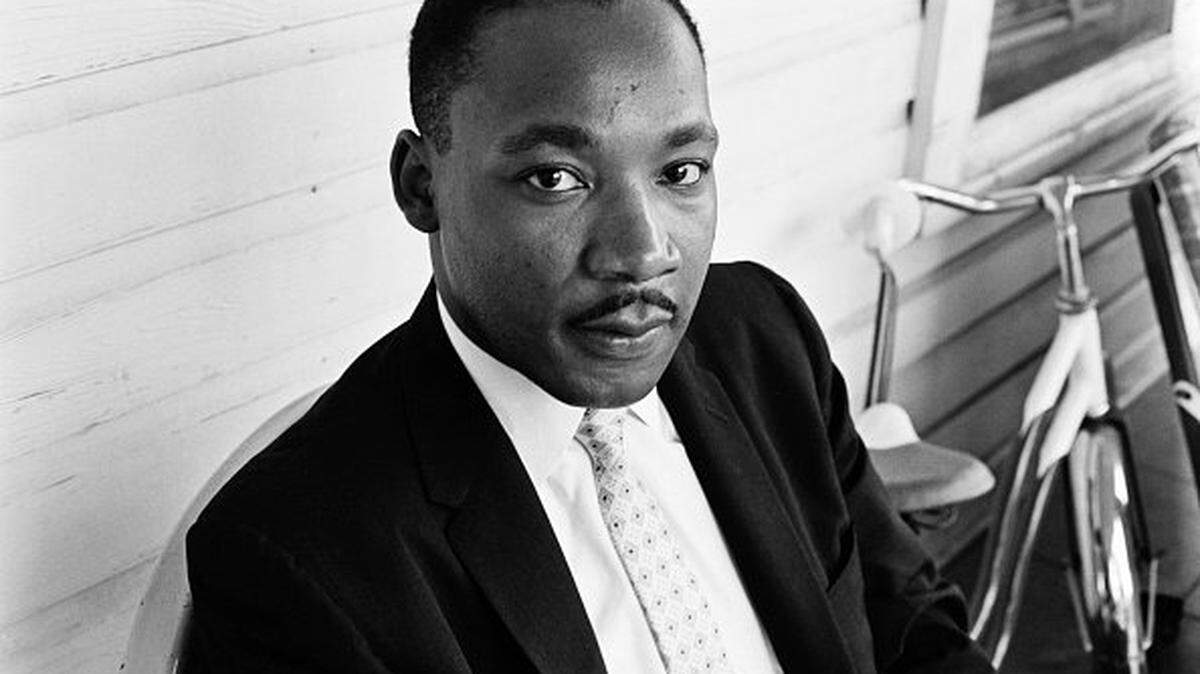 American Baptist minister and civil rights activist Martin Luther King Jr sits outside a property in Montgomery, Alabama, US, May 1961. (Photo by Daily Express/Hulton Archive/Getty Images)