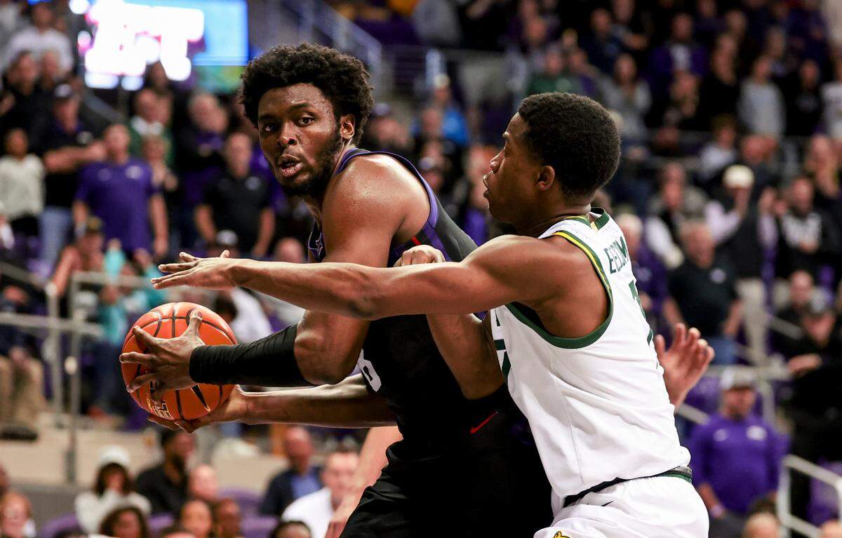 Mar 4, 2025; Fort Worth, Texas, USA; TCU Horned Frogs center Ernest Udeh Jr. (8) looks to pass as Baylor Bears guard VJ Edgecombe (7) defends during the second half at Ed and Rae Schollmaier Arena. Mandatory Credit: Kevin Jairaj-Imagn Images