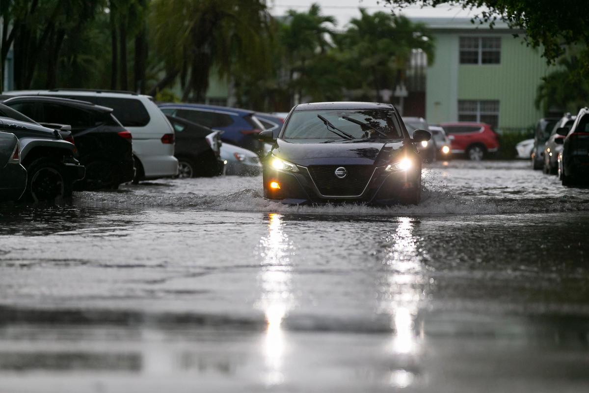 Cars approach Harding Avenue on 86th Street in Surfside as heavy rain and thunderstorms made their way across South Florida in this file photo from July 12, 2021.