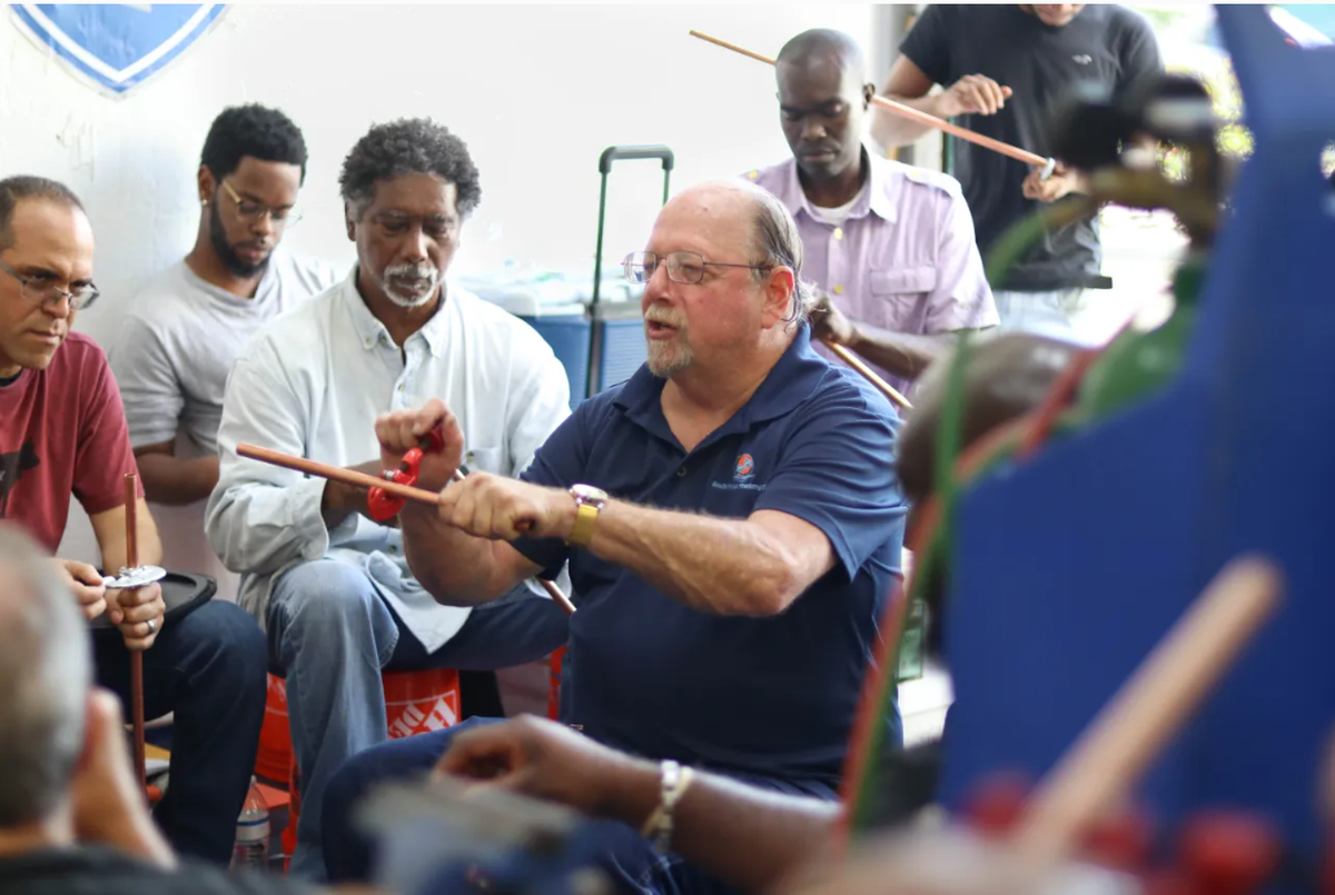 Richard Buckley, head instructor at the South Florida Academy of Air Conditioning in Fort Lauderdale, demonstrates how to cut copper tubing in a lesson at the academy’s welding warehouse.