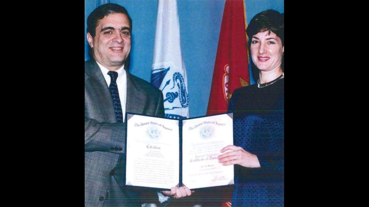 Ana Belén Montes receives the National Intelligence Certificate of Distinction from then-deputy Director of Central Intelligence George Tenet on Feb. 21, 1997.
