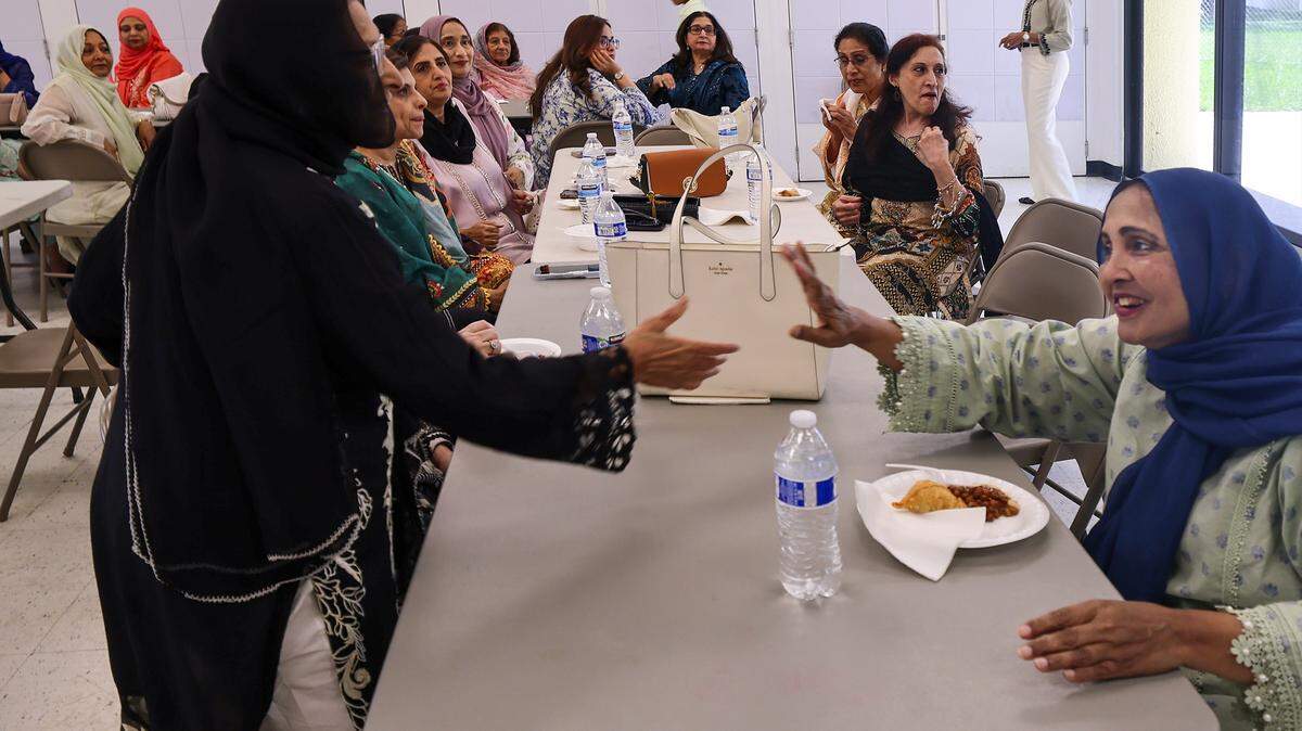 Women greet each other at the Kendall Social Club at Kendale Lakes Park clubhouse on Sunday, Sept. 15, 2025.