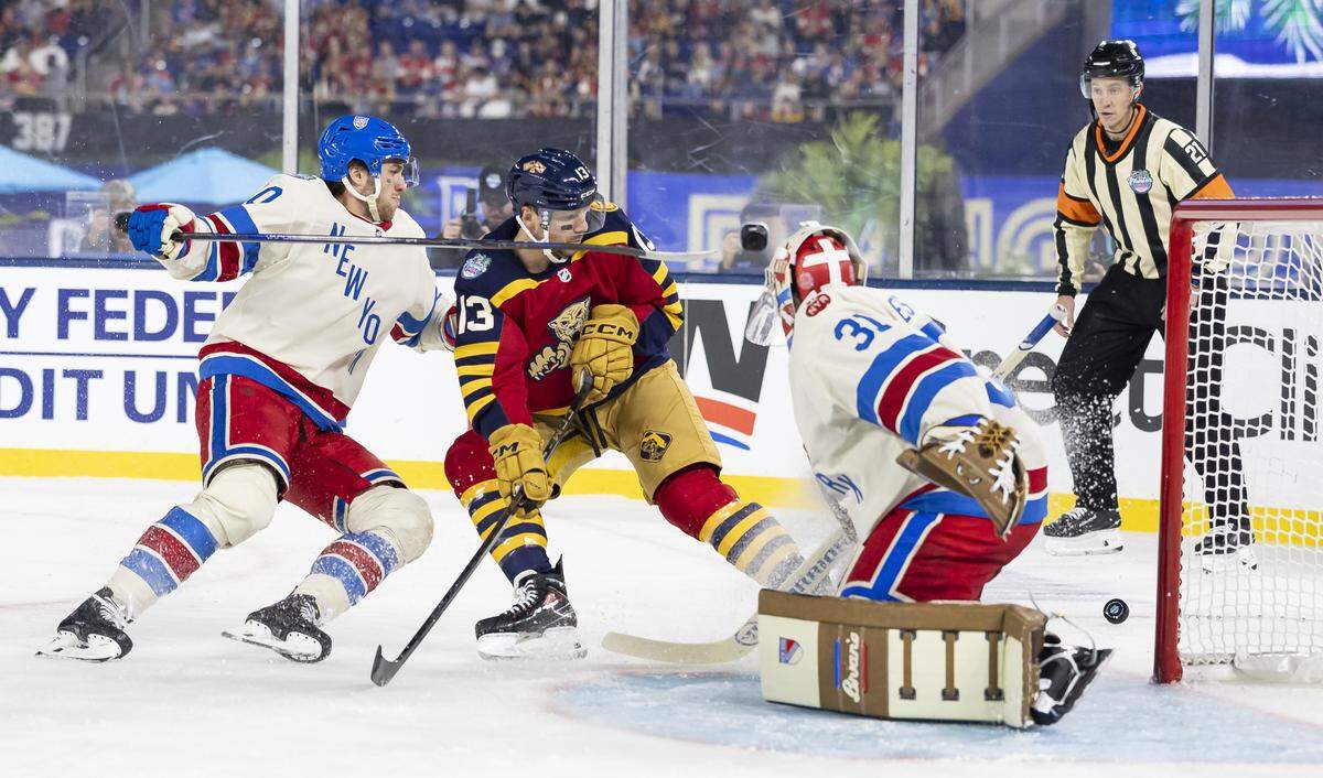 Florida Panthers center Sam Reinhart (13) tries to score as New York Rangers goaltender Igor Shesterkin (31) defends in the first period of their Winter Classic outdoor hockey game at loanDepot park on Friday, Jan. 2, 2025, in Miami, Fla.