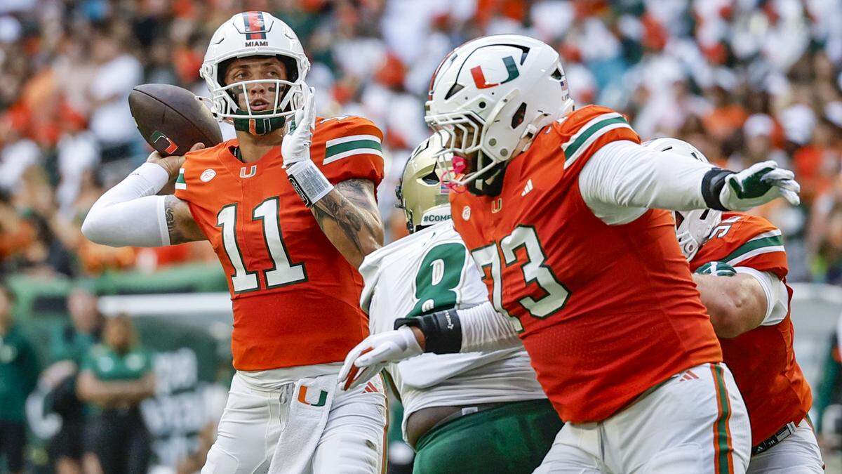 Miami Hurricanes quarterback Carson Beck (11) sets up for a touchdown pass to wide receiver Joshua Moore (3) in the first half of the NCAA football game against the South Florida Bulls at Hard Rock Stadium in Miami Gardens, Florida, on Saturday, September 13, 2025. 