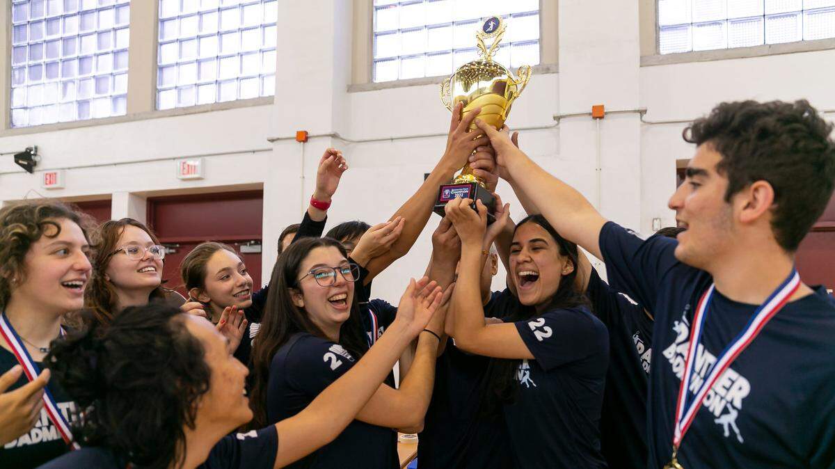Miami Palmetto Senior High School badminton players celebrate with their trophy after winning the GMAC championship at Barbara Goleman High School in Miami Lakes, Florida on Wednesday, April 20, 2022.