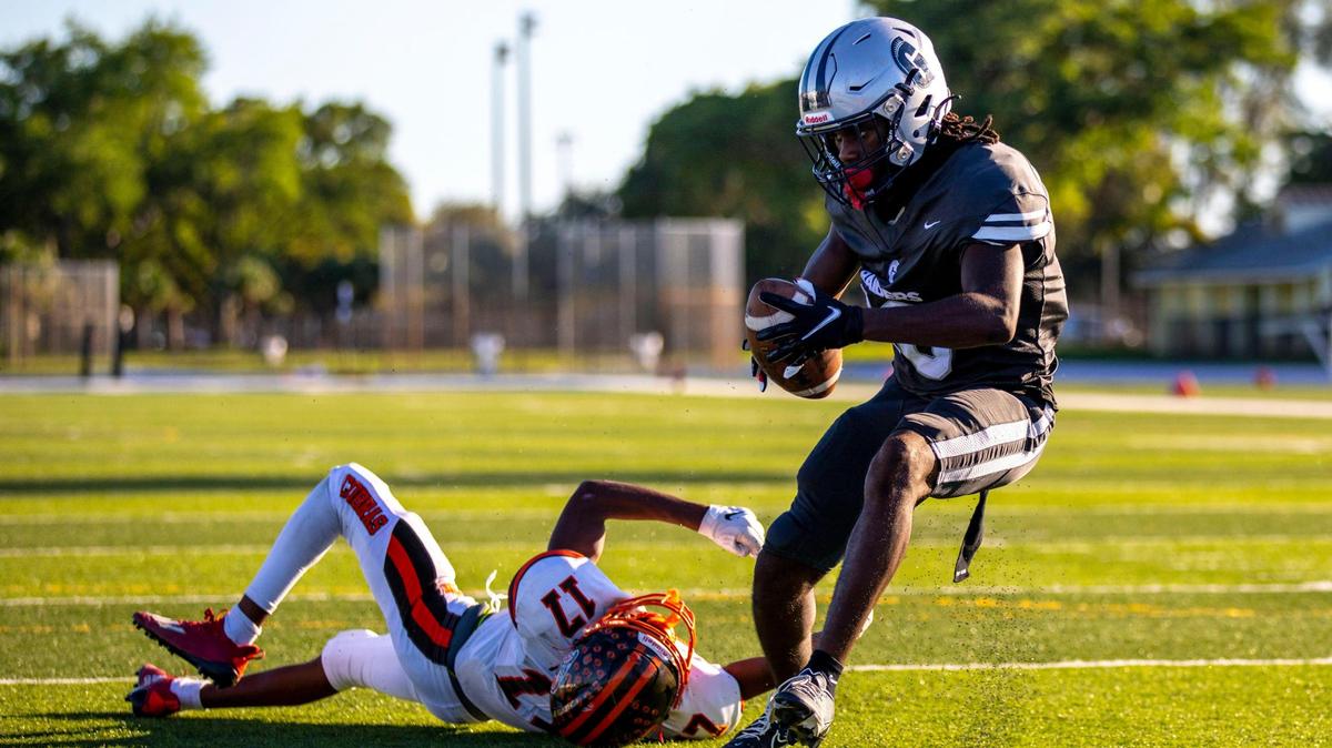 Gulliver Prep wide receiver Antwaan Mays (16) makes the catch while defended by South Miami High defensive back Elijah Douyon (17) before scoring a touchdown during a high school football game at Tropical Park Stadium in Miami, Florida, on Thursday, October 27, 2022.