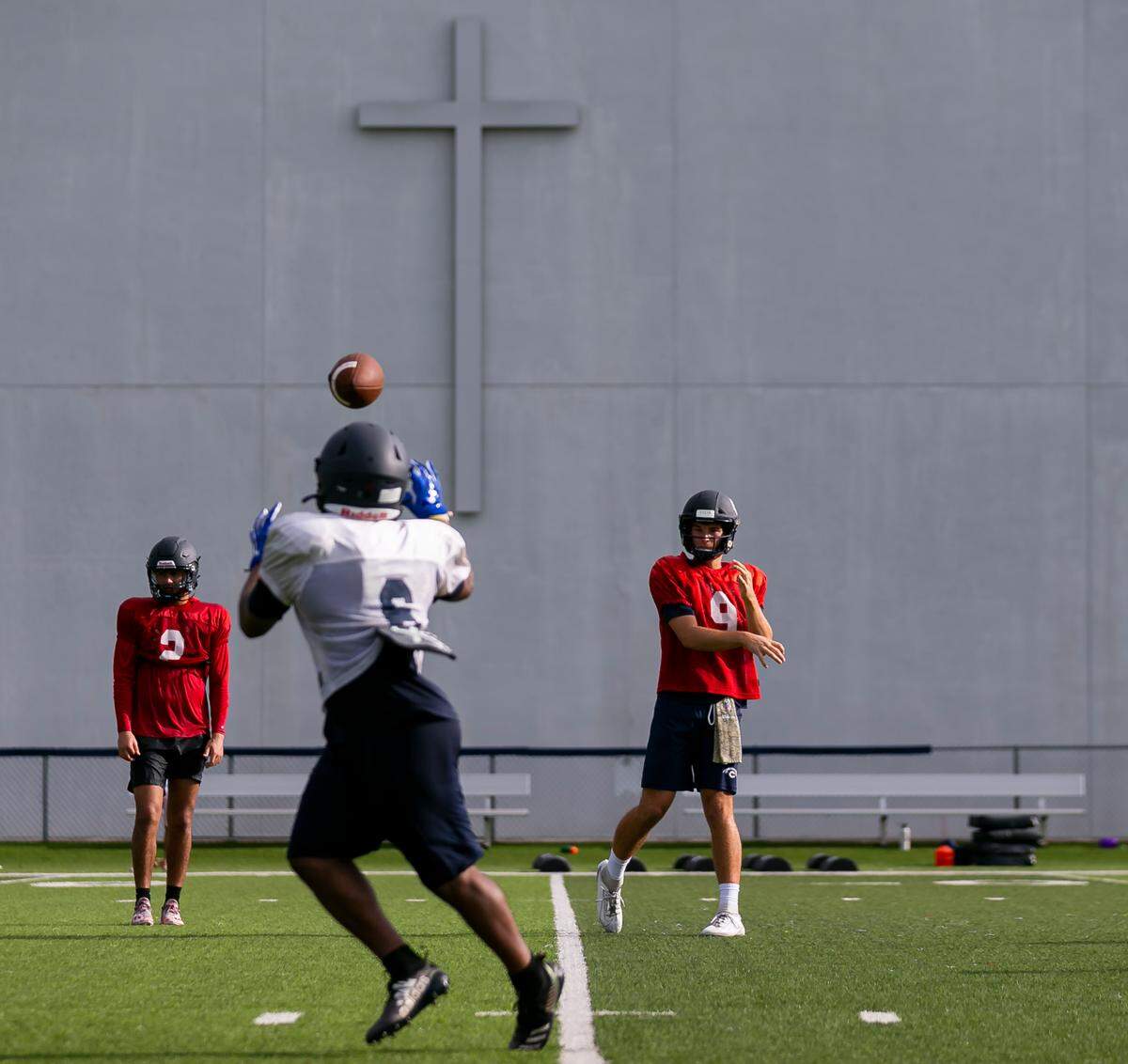 Christopher Columbus quarterback Fernando Mendoza throws a ball to running back Denim Edwards during a preseason practice at their school in Miami’s Westchester neighborhood on Wednesday, August 4, 2021.