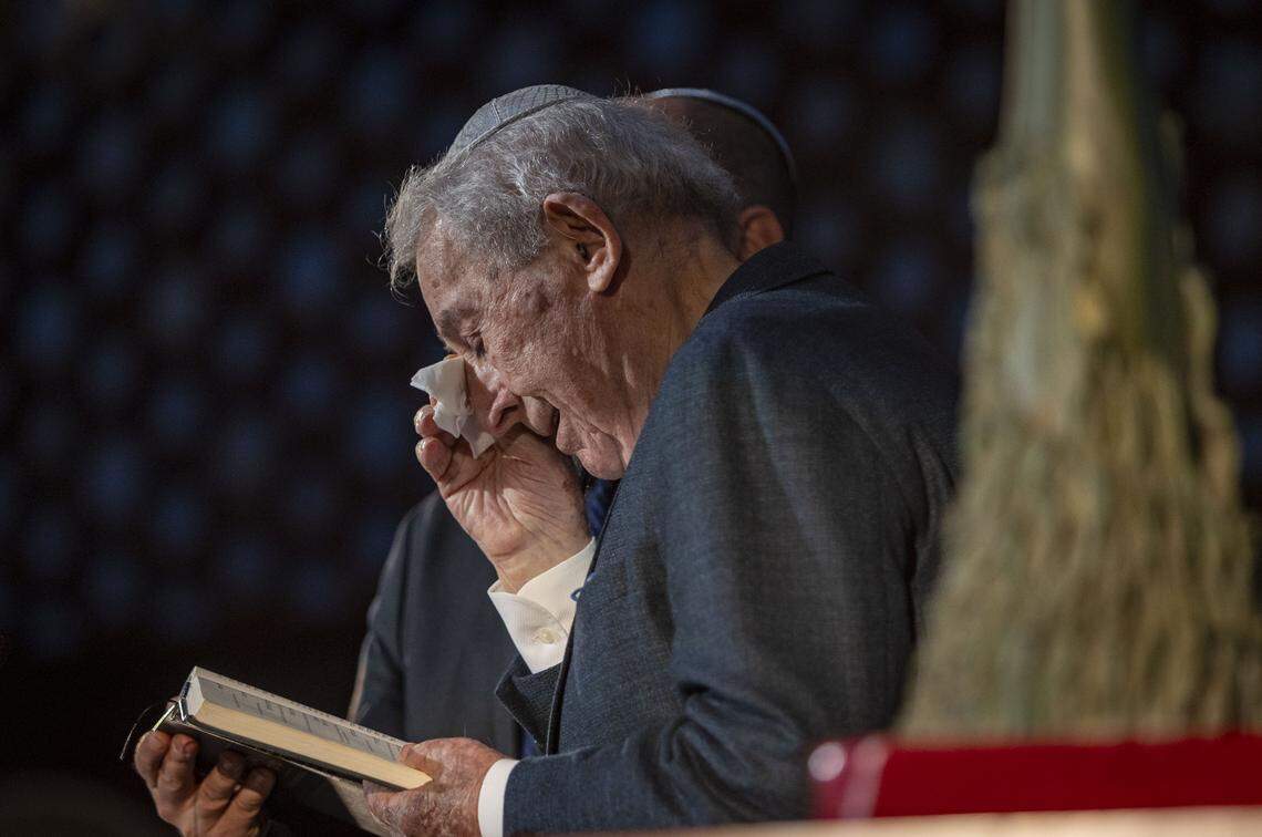 On April 27, 2025, Holocaust survivor David Schaecter, wipes a tear from his eye as he read the Mourner’s Kaddish along with Cantor Gastón Bogomoini during a ceremony to Commemorate Yom HaShoah, Holocaust Remembrance Day at Temple Emanu-El in Miami Beach.