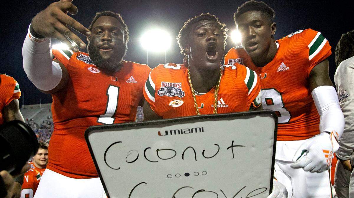 Miami Hurricanes linebacker Gilbert Frierson (3) celebrates with the turnover chain with defensive lineman Nesta Jade Silvera (1) and cornerback DJ Ivey (8) after Frierson intercepts the ball late in the third quarter as the Miami Hurricanes play Louisiana Tech in the Walk On’s Independence Bowl at Independence Stadium, Shreveport, Louisiana on Thursday, December 26, 2019.