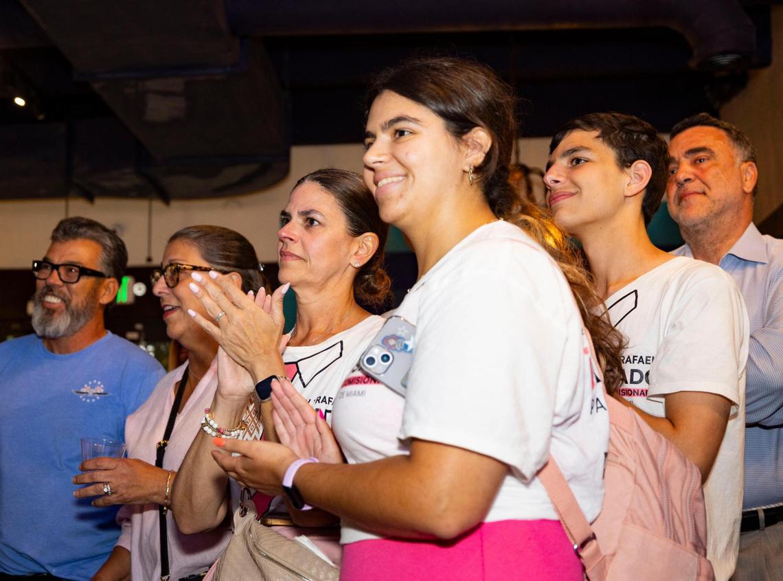 Ralph Rosado’s wife, Mari, center, daughter Mia, center right, and son Matias, right, clap during Ralph Rosado’s watch party on Tuesday, June 3, 2025, at El Atlacatl restaurant in Miami.