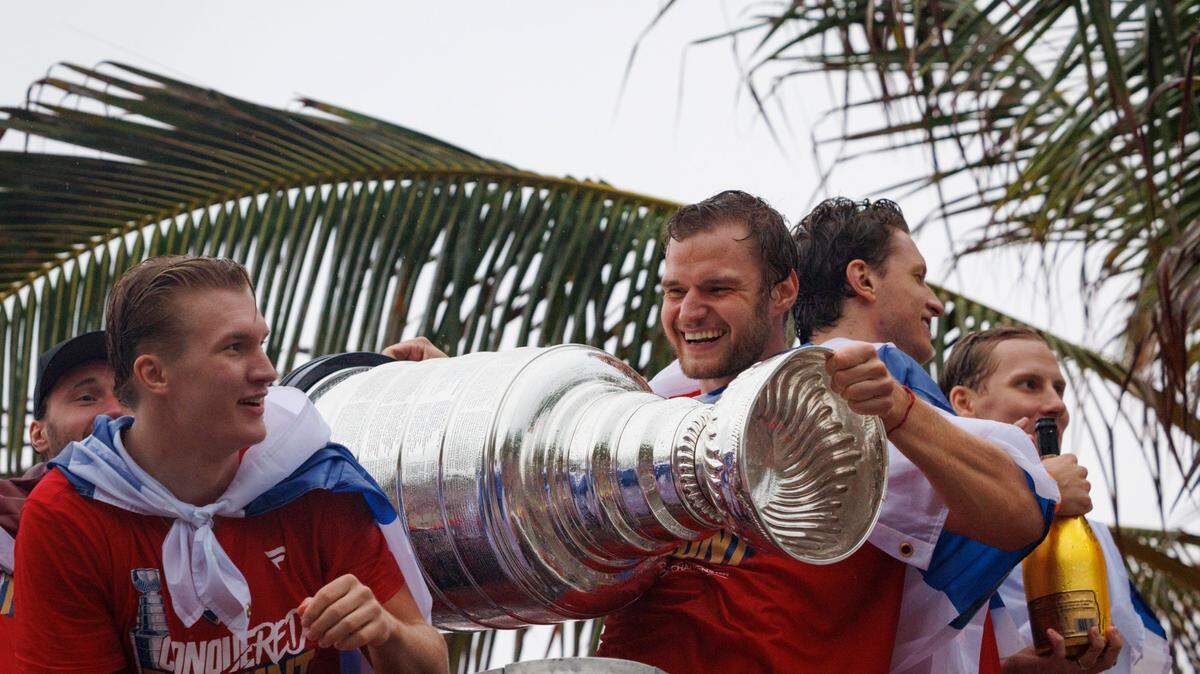 Florida Panthers center Aleksander Barkov (16) smiles while holding the Stanley Cup with teammates during the Florida Panthers Stanley Cup Victory parade on Sunday, June 30, 2024 down Fort Lauderdale Beach. 