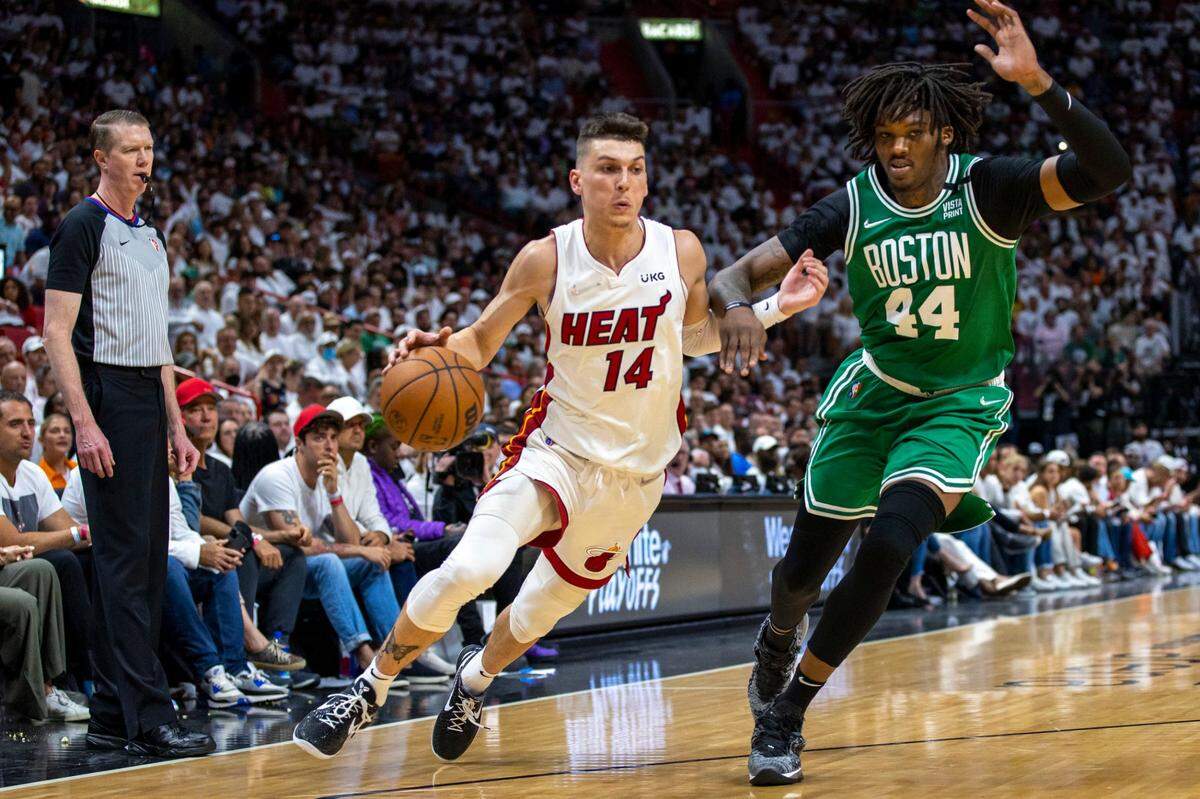 Miami Heat guard Tyler Herro (14) dribbles past Boston Celtics center Robert Williams III (44) during the fourth quarter of Game 1 of the NBA Eastern Conference Finals series at FTX Arena in Miami on May 17, 2022.