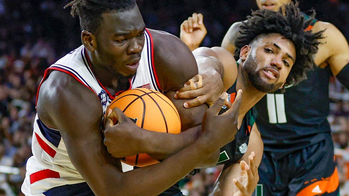 Connecticut Huskies forward Adama Sanogo (21) pulls down a rebound against Miami Hurricanes forward Norchad Omier (15) during the second half of the Men’s Basketball Championship National Semifinal at NRG Stadium in Houston, Texas on Saturday, April 1, 2023.