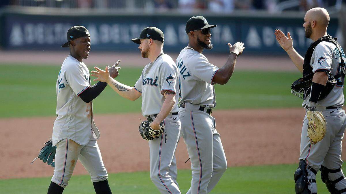 Miami Marlins from left, Jazz Chisholm Jr., Louis Head, Bryan De La Cruz, and Jacob Stallings celebrate the 5-4 win over the Atlanta Braves at the end of a baseball game Sunday, April 24, 2022, in Atlanta. (AP Photo/Ben Margot)