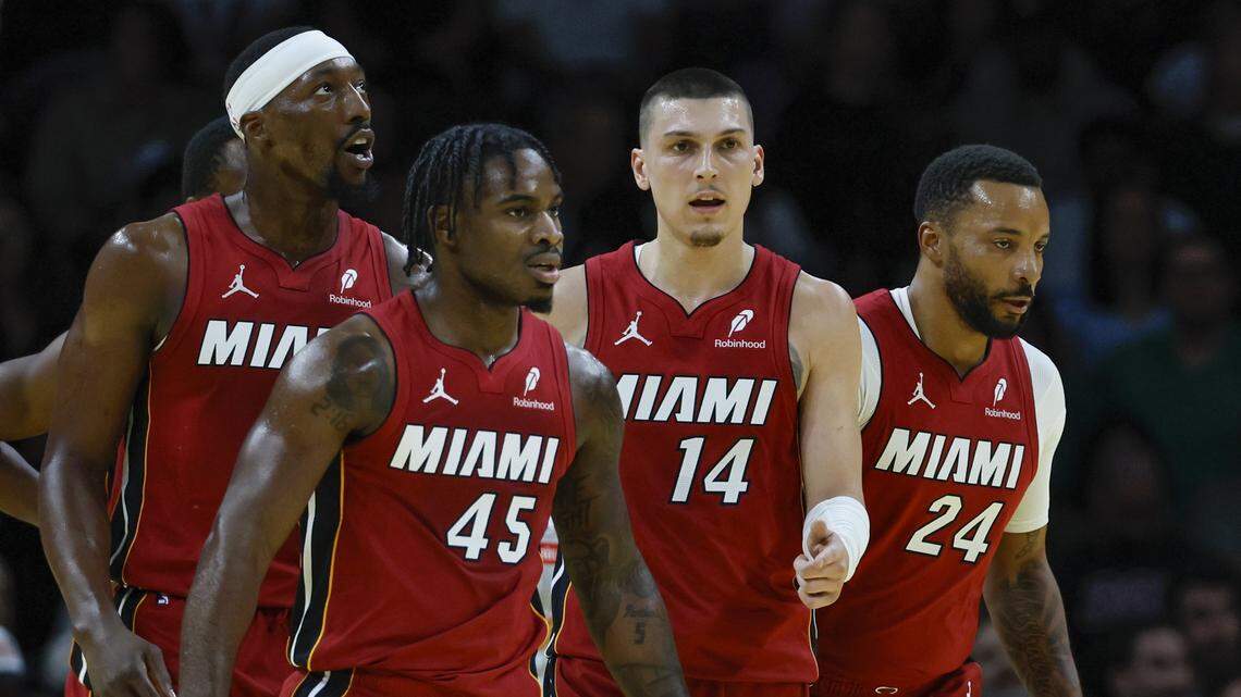 Miami Heat center/forward Bam Adebayo (13), guard Davion Mitchell (45), guard Tyler Herro (14), and guard Norman Powell (24) walk together on the court during their NBA basketball game against the Milwaukee Bucks at Kaseya Center on November 26, 2025.