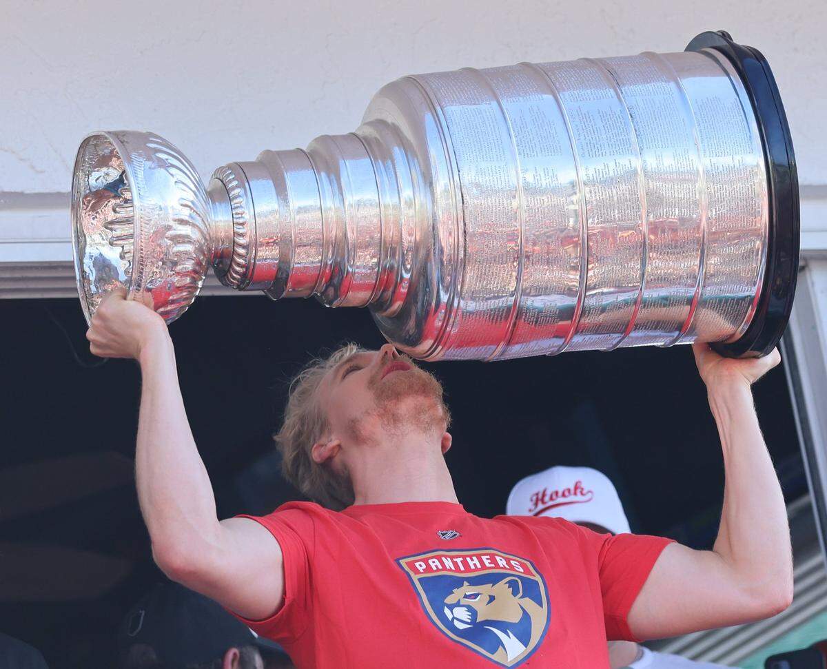 Gustav Forsling kisses the trophy on the balcony of the Elbo Room in Fort Lauderdale after the Florida Panthers won the Stanley Cup Final for the second time on Wednesday, June 18, 2025.